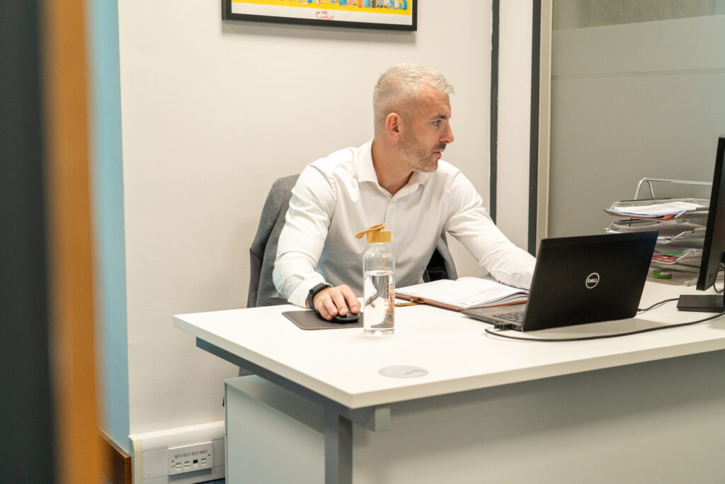 An Inspire Medical consultant working through doctor credentials at his desk